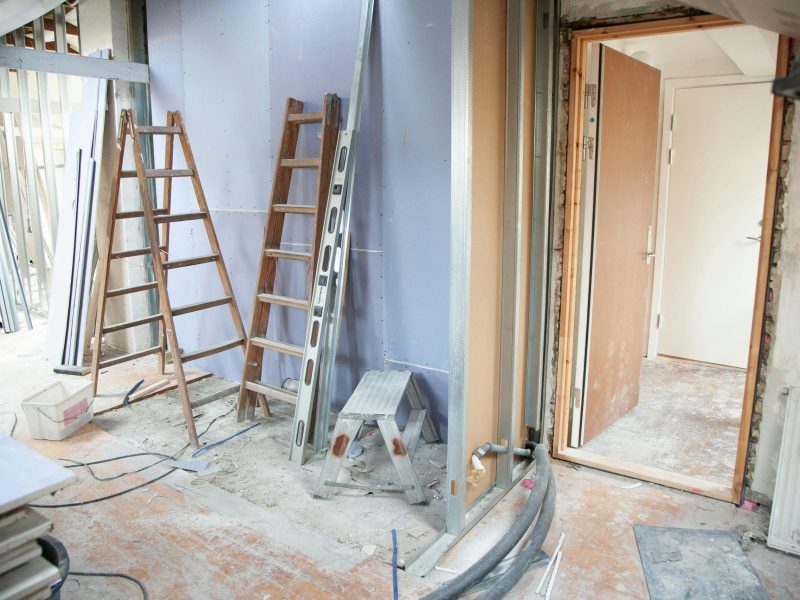 pexels-photo-3990359-3990359 Construction site featuring ladders and tools in a home renovation setting.